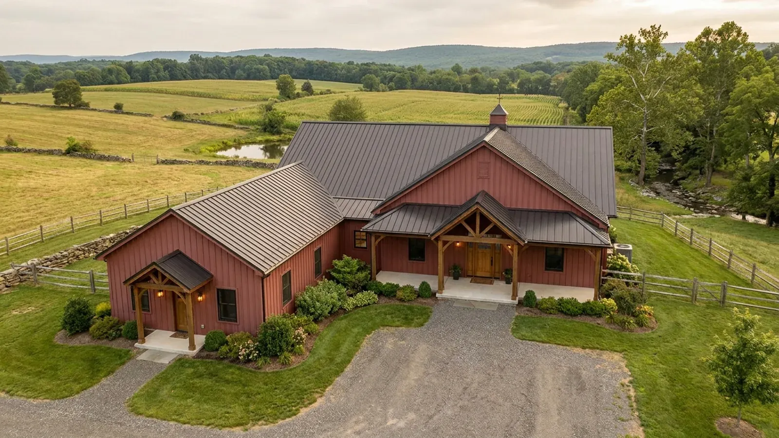 A barndominium with a smaller attached in-law suite wing that has its own separate covered entry, distinct from the main entry.